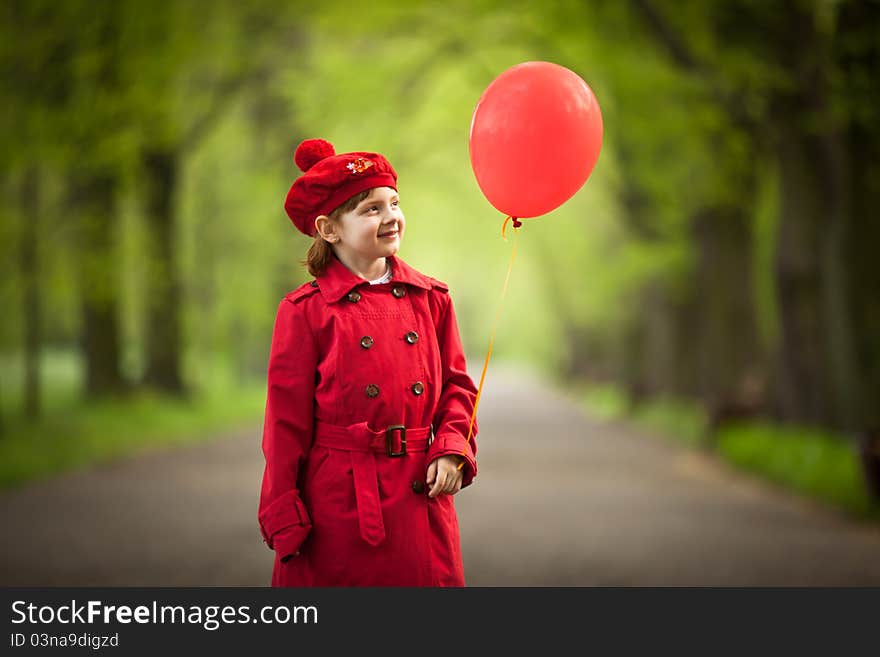 Girl wears in a red coat holding red balloon. Girl wears in a red coat holding red balloon