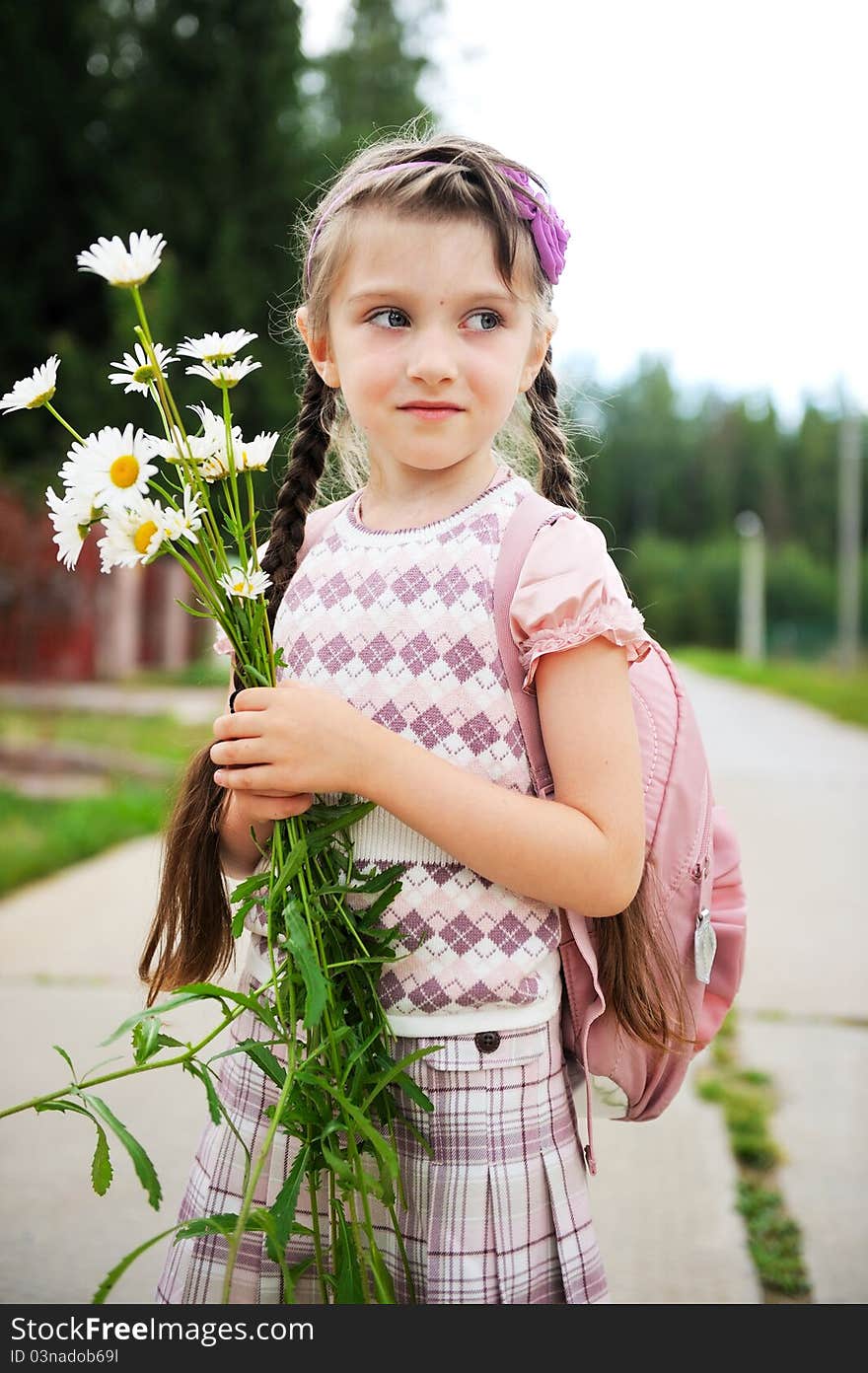 Young girl with pink bagpack ready for school