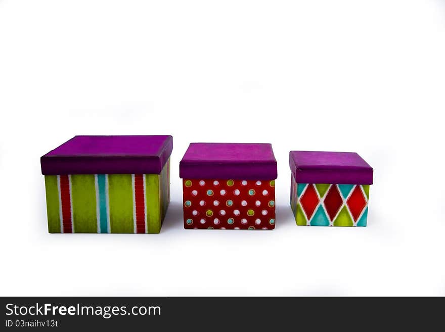 Presents a box on a white background in the green and red with purple lid. Presents a box on a white background in the green and red with purple lid