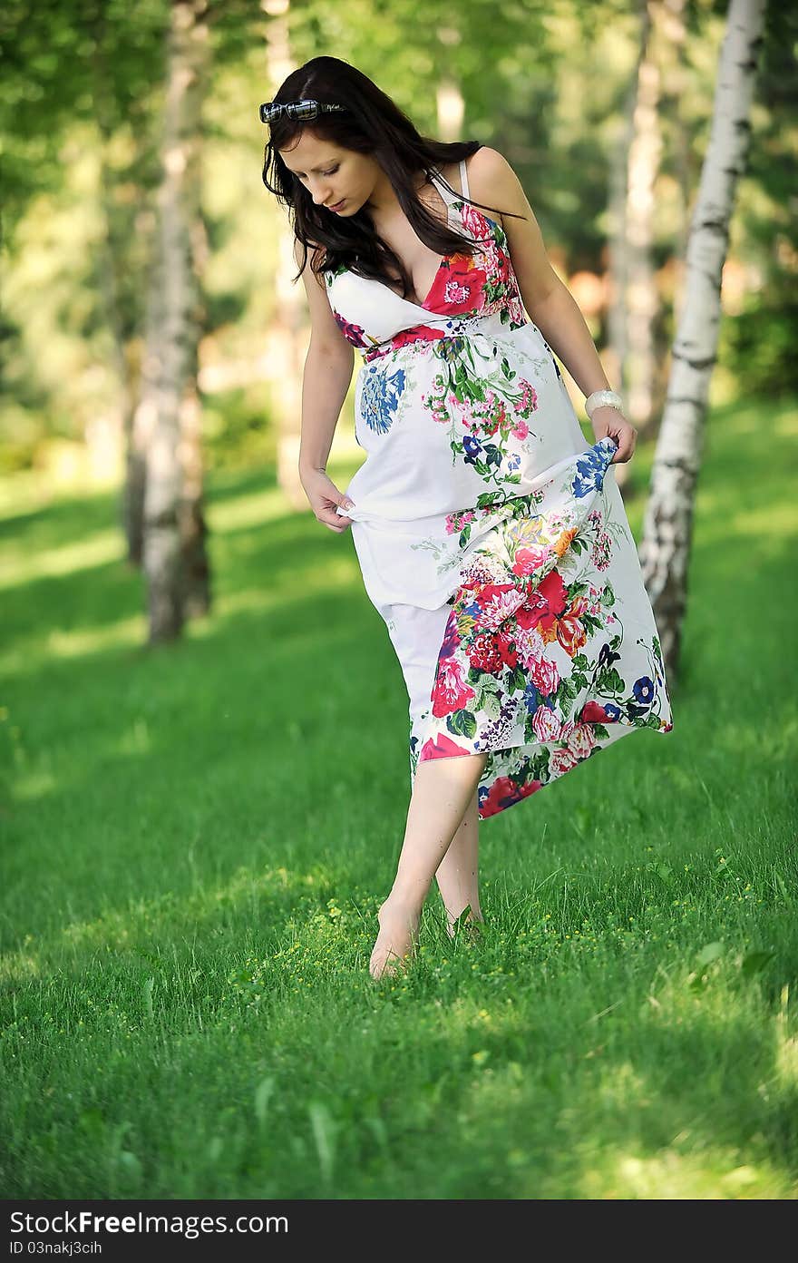 Beautiful woman walking on grass in birch grove . summer's day. Beautiful woman walking on grass in birch grove . summer's day.