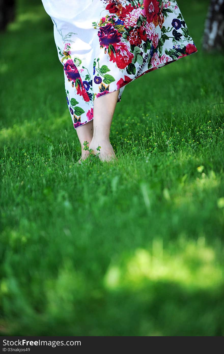 Woman's feet walking barefoot on grass. summer's day. Woman's feet walking barefoot on grass. summer's day