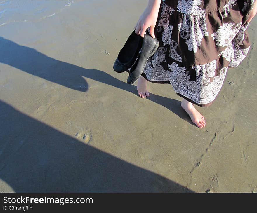 Walking barefoot on the wet sand as the water washes away your prints. Walking barefoot on the wet sand as the water washes away your prints