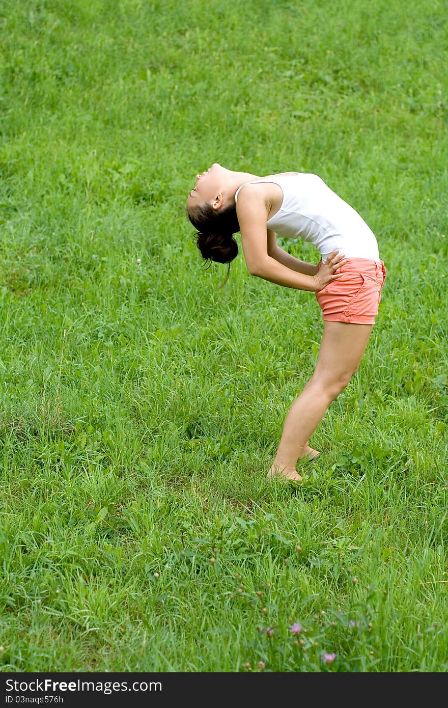 Girl doing exercises in park
