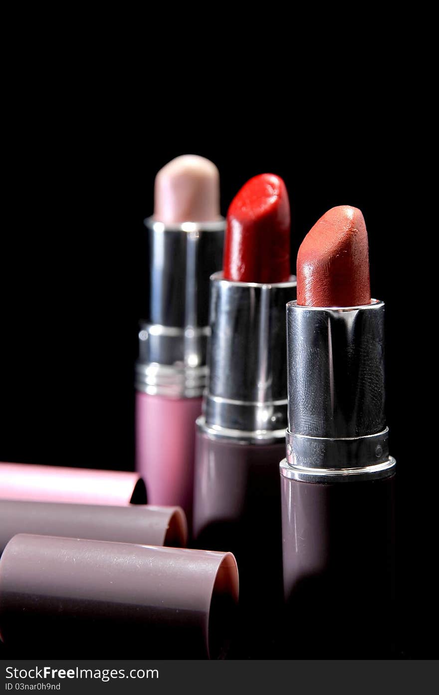 Three lipsticks in different colours