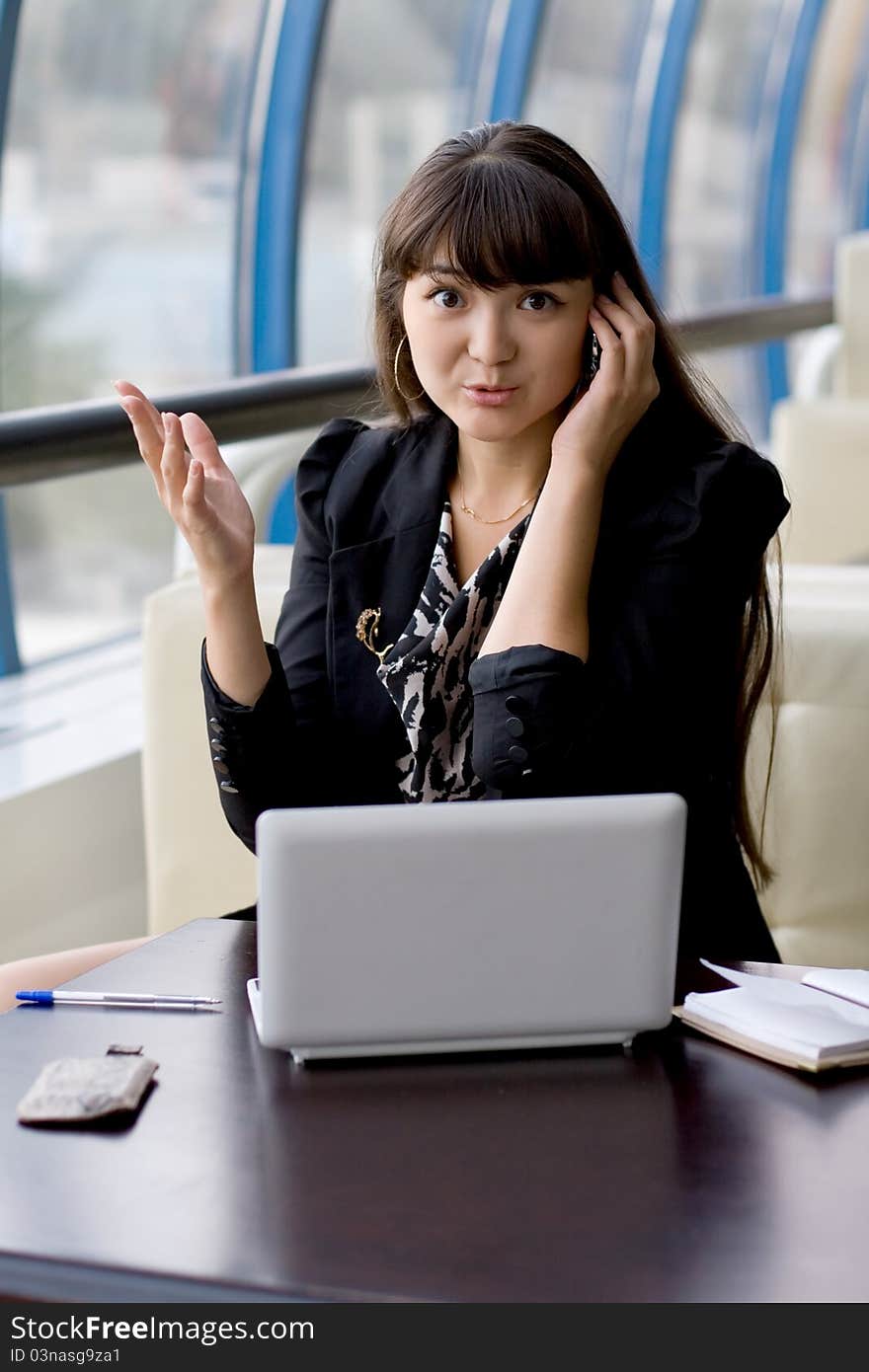 Businesswoman speaking by phone indoor