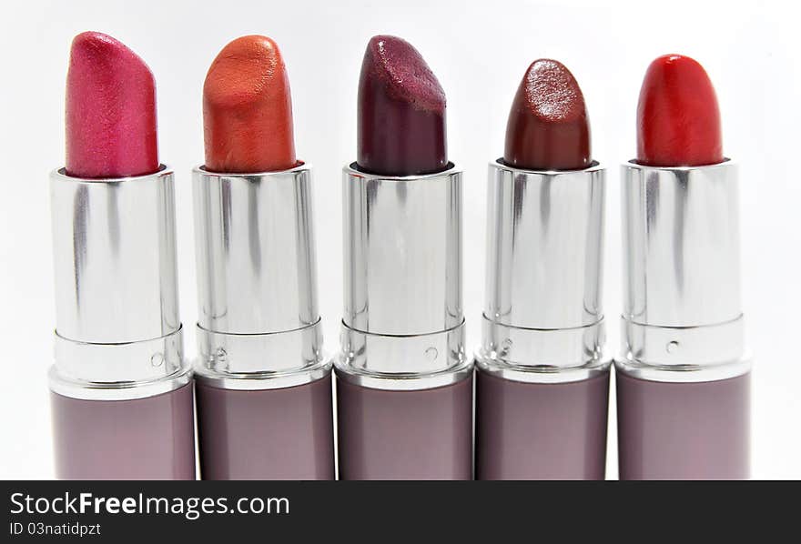 Lipsticks in different colours isolated on white - copy space