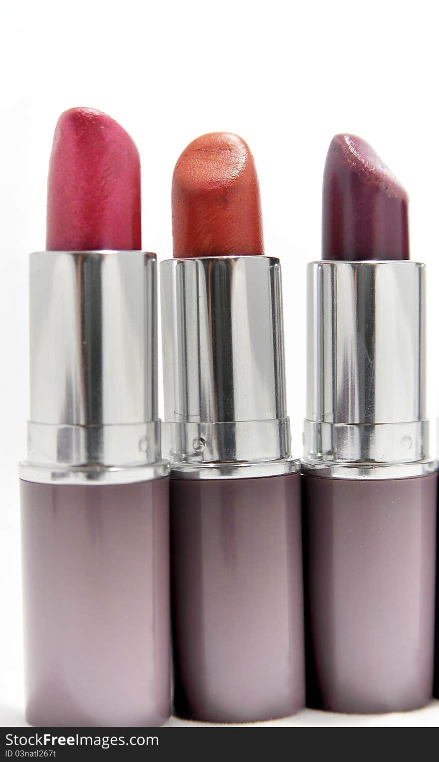 Three lipsticks in different colours - copy space