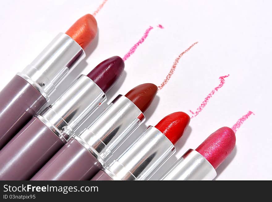 Lipsticks in different colours with trace - copy space