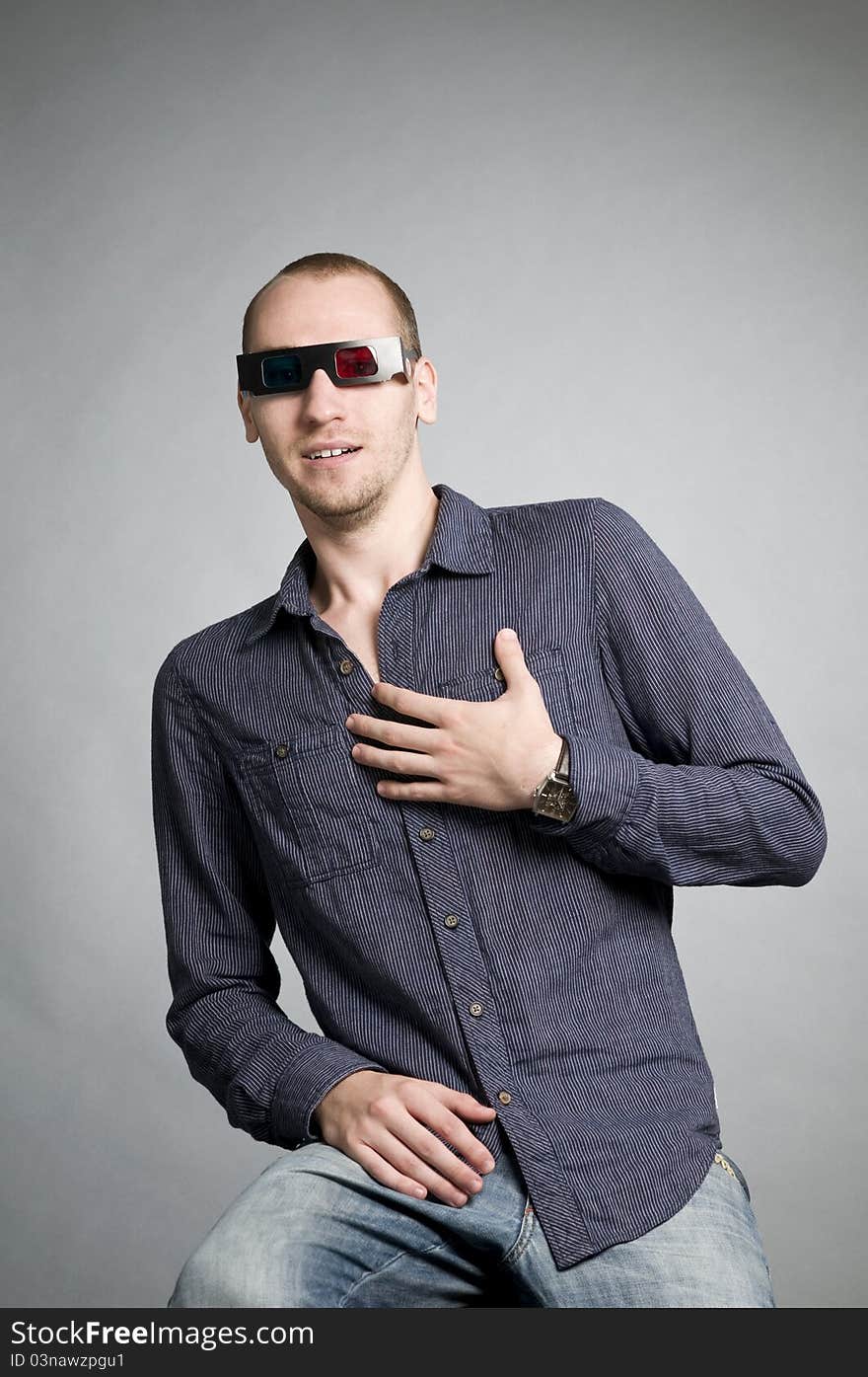 Young man watching movies with 3d glasses