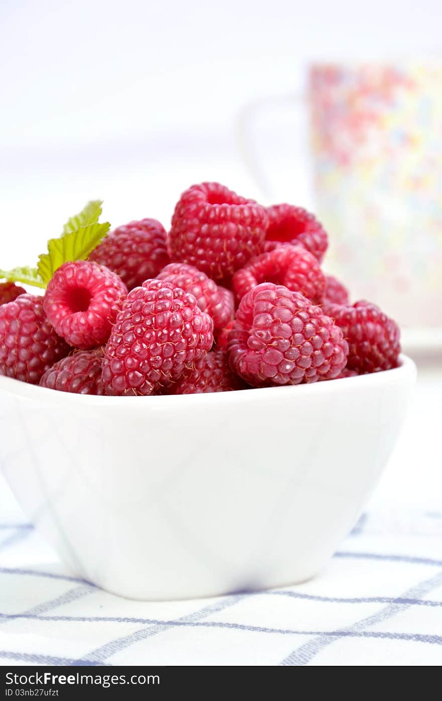 Raspberries In A White Bowl