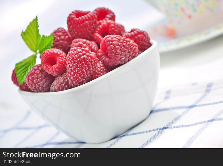 Raspberries in a white bowl