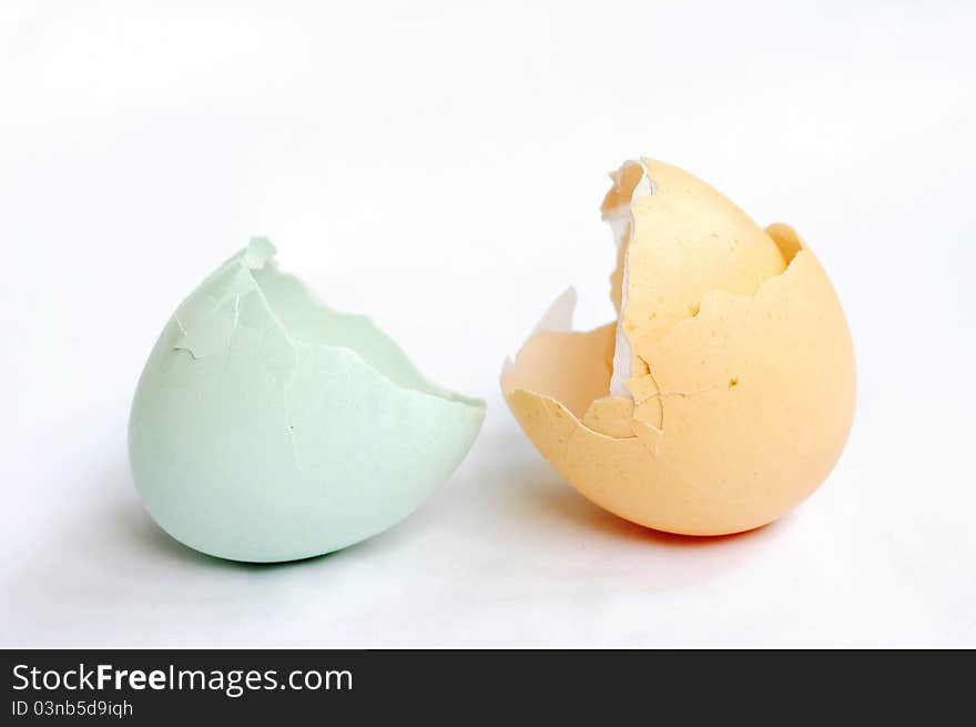 Broken empty eggshells on a white background