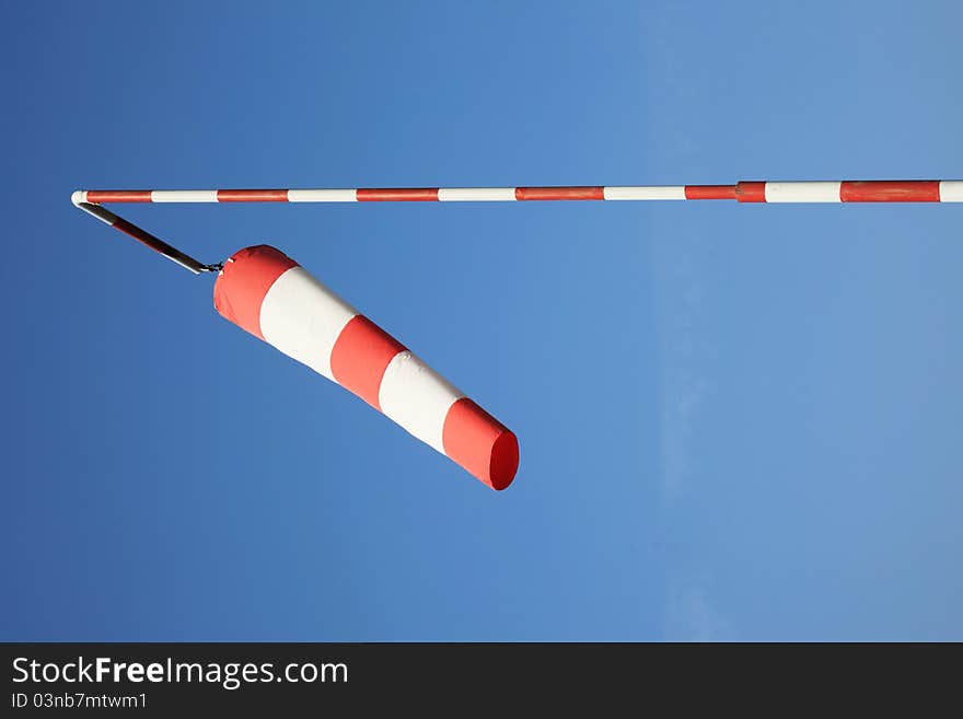 Red and white wind flag, blue sky on the background. Red and white wind flag, blue sky on the background.