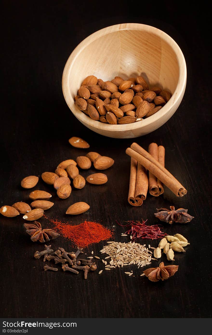 Bowl of almonds and mix of spices on black table. Bowl of almonds and mix of spices on black table