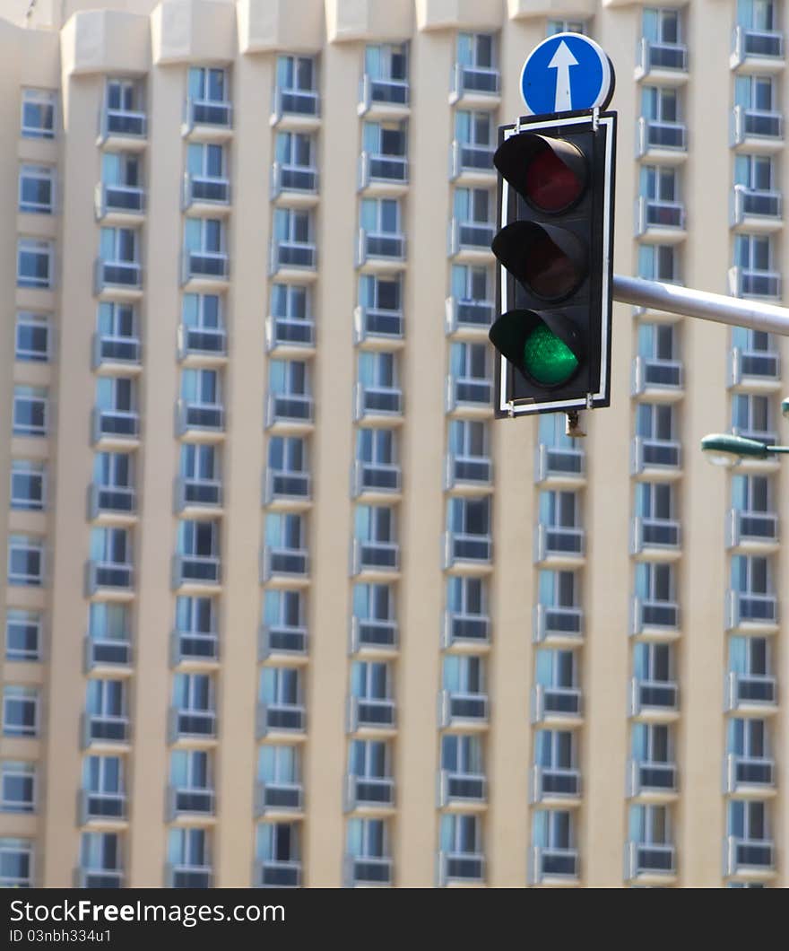 Road lights showing green, with skyscraper on background. Road lights showing green, with skyscraper on background