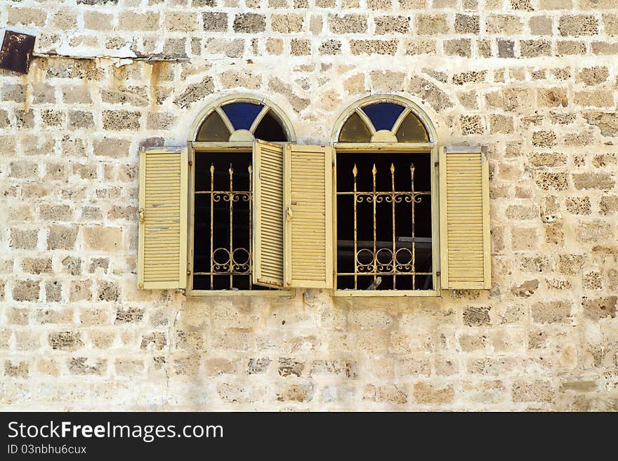 Asian stlyle windows in a yellow brick wall