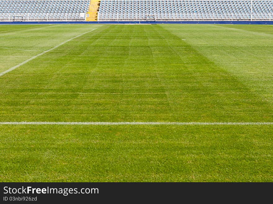 Empty stadium with chairs and green