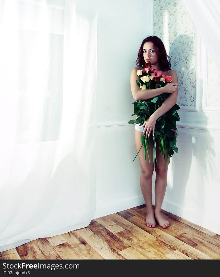 Photo beautiful girl with flowers in the interior. Photo beautiful girl with flowers in the interior