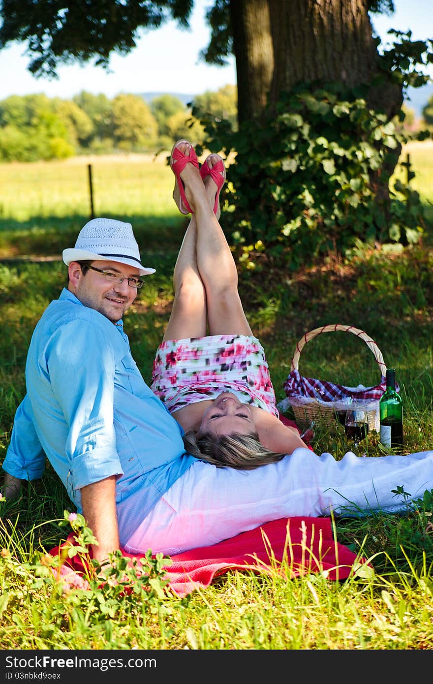 Middle aged couple enjoying picnic in the park