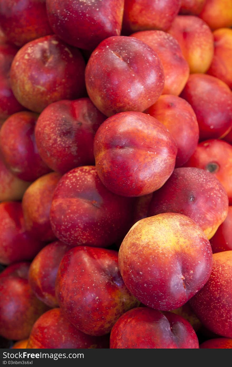 Red nectarines on display in a market