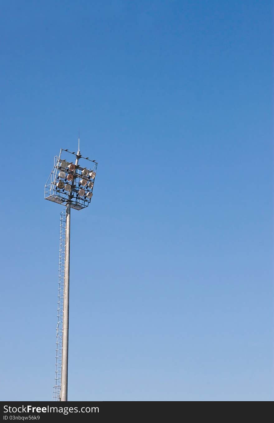 Sport light pole against blue sky background