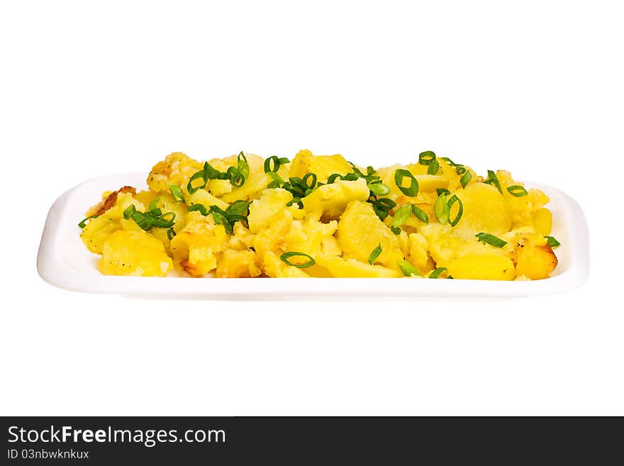 Baked potatoes and green spring onions rings