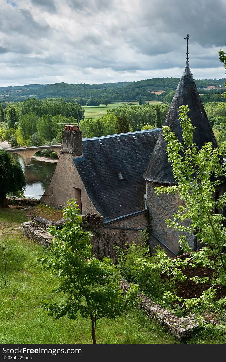 French Chateau with view of river behind and storm clouds