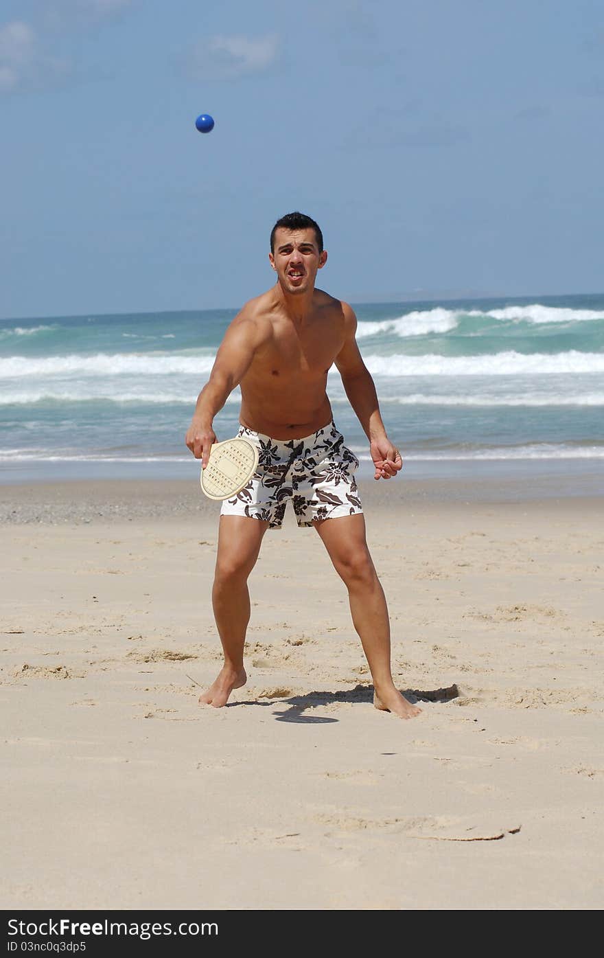 Attractive Men Playing Beach Tennis