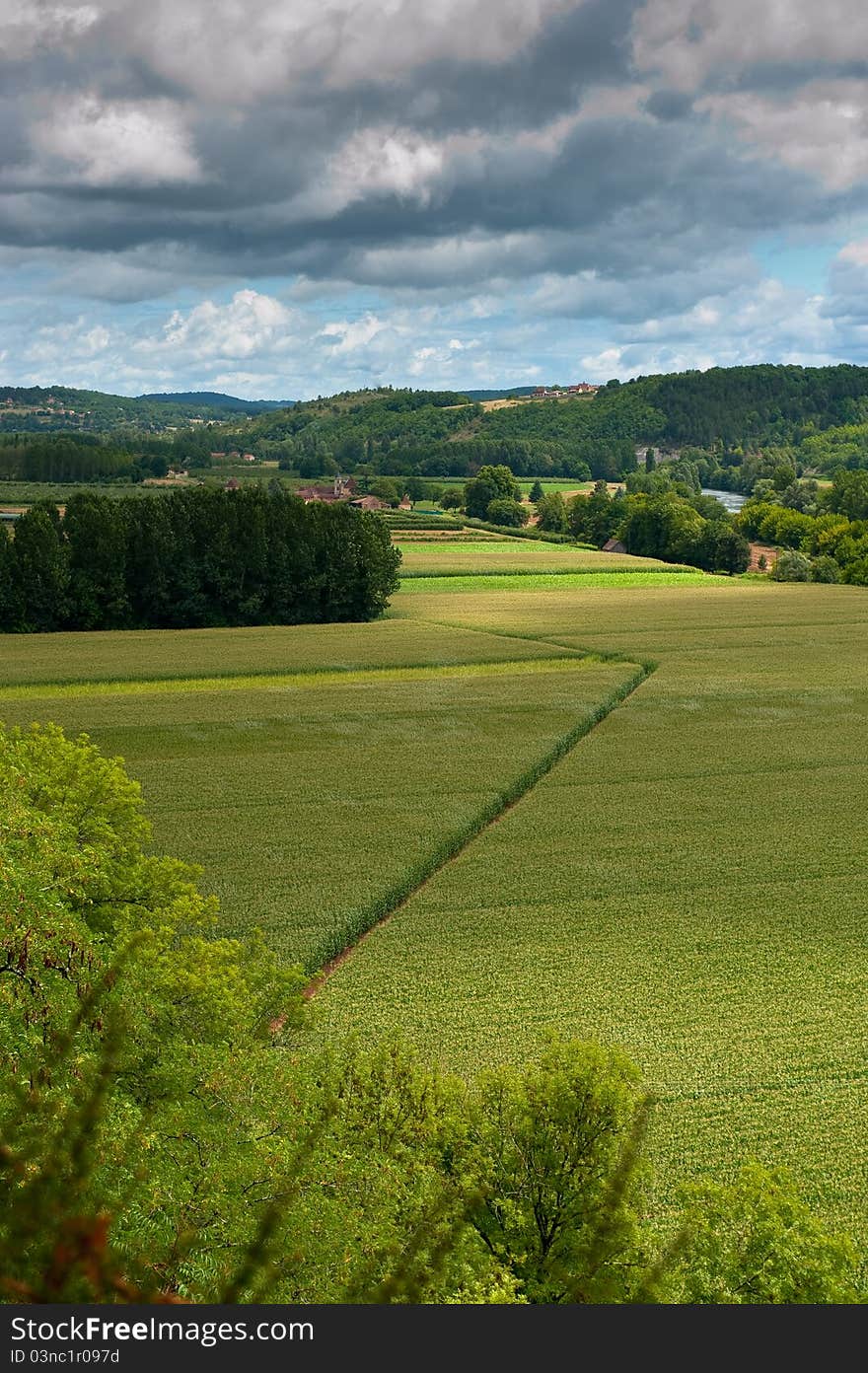 Diagonal line over a French field with dark skies over. Diagonal line over a French field with dark skies over