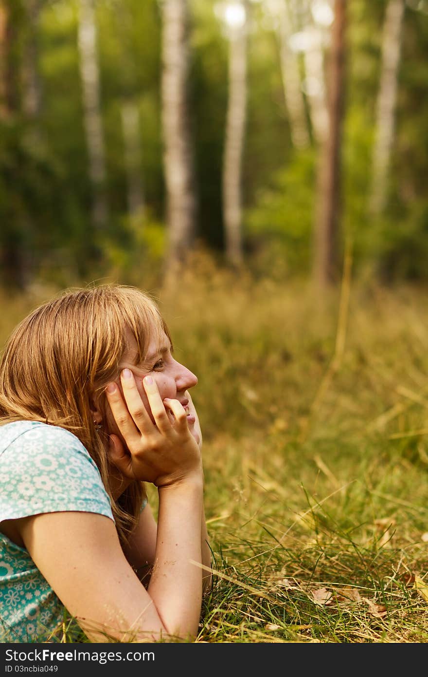 Young woman dreaming in summer nature