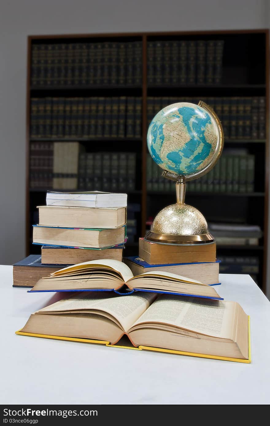 Pile of books and globe balls in library