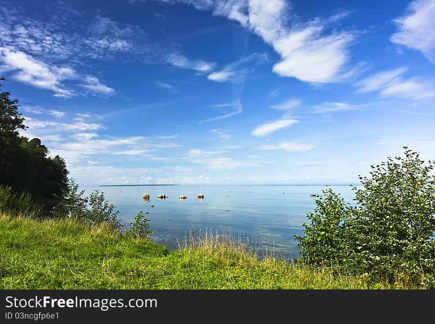 Idyllic seashore landscape with green grass, blue sky and vivid clouds. Idyllic seashore landscape with green grass, blue sky and vivid clouds