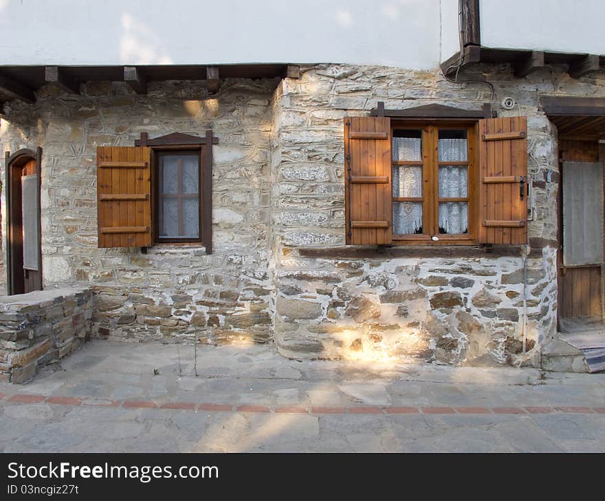 Old stone house with wooden doors windows and balkony in a greek vilage in halkidiki