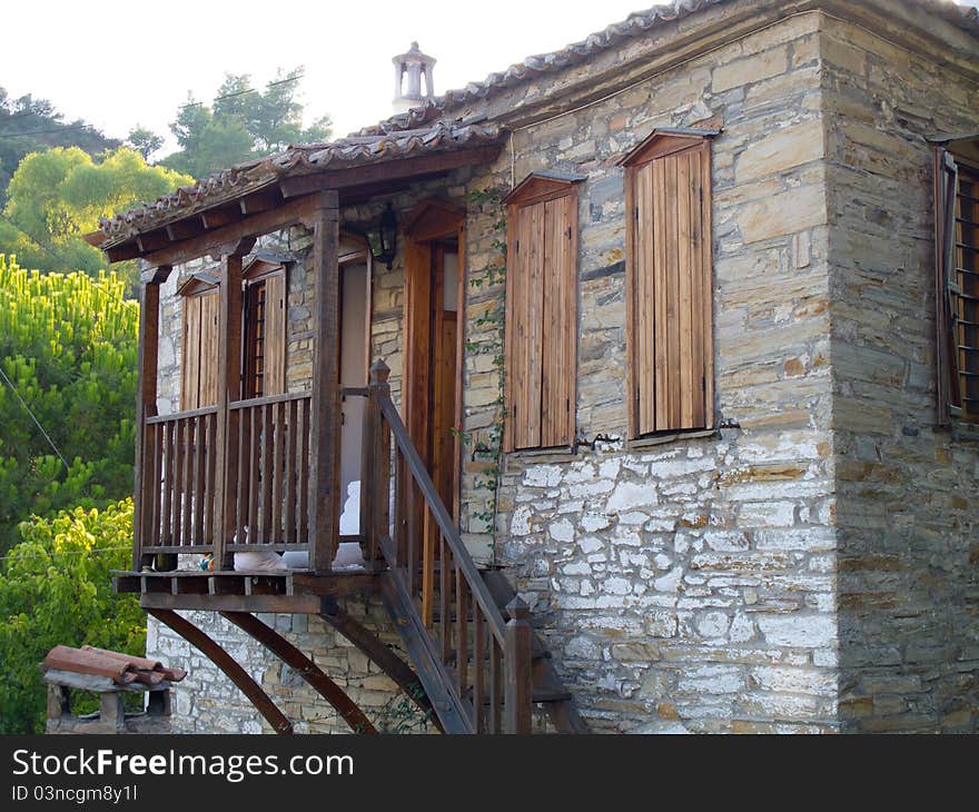 Old stone house with wooden doors windows and balkony in a greek vilage in halkidiki