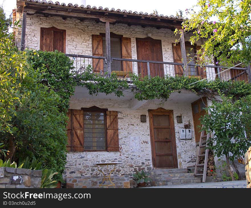 Old stone house with wooden doors windows and balkony in a greek vilage in halkidiki