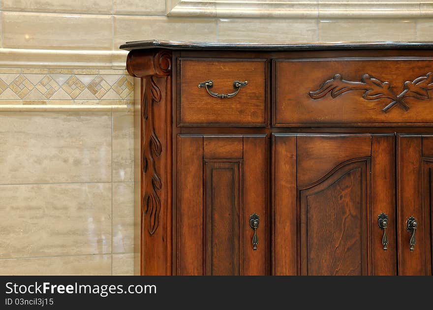 Part of wooden ark in room interior, shown as beautiful color and texture, with elaborate carving pattern, shown as traditional and comfortable life style.