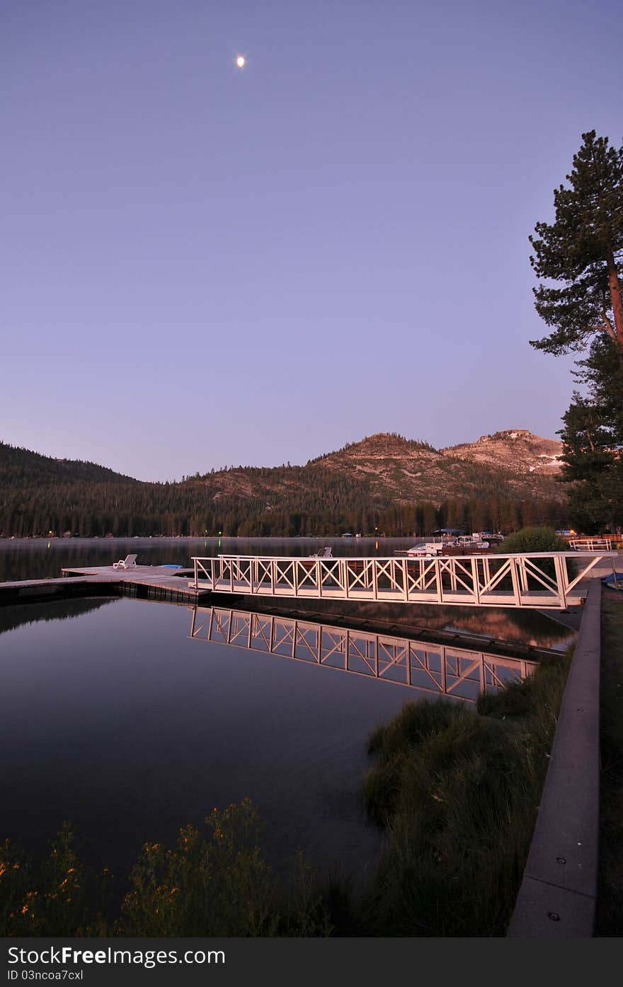 Dock on a calm lake with reflection