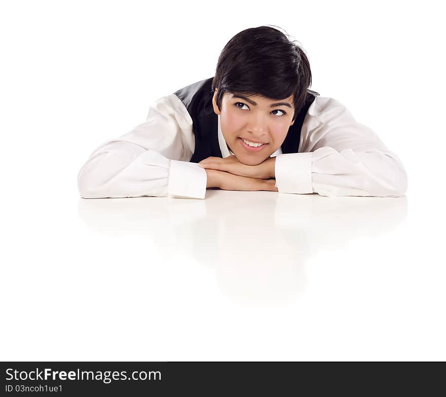 Attractive Smiling Mixed Race Young Adult Female Looking Up and Away Sitting At White Table Resting Her Head on Her Hands on a White Background. Attractive Smiling Mixed Race Young Adult Female Looking Up and Away Sitting At White Table Resting Her Head on Her Hands on a White Background.