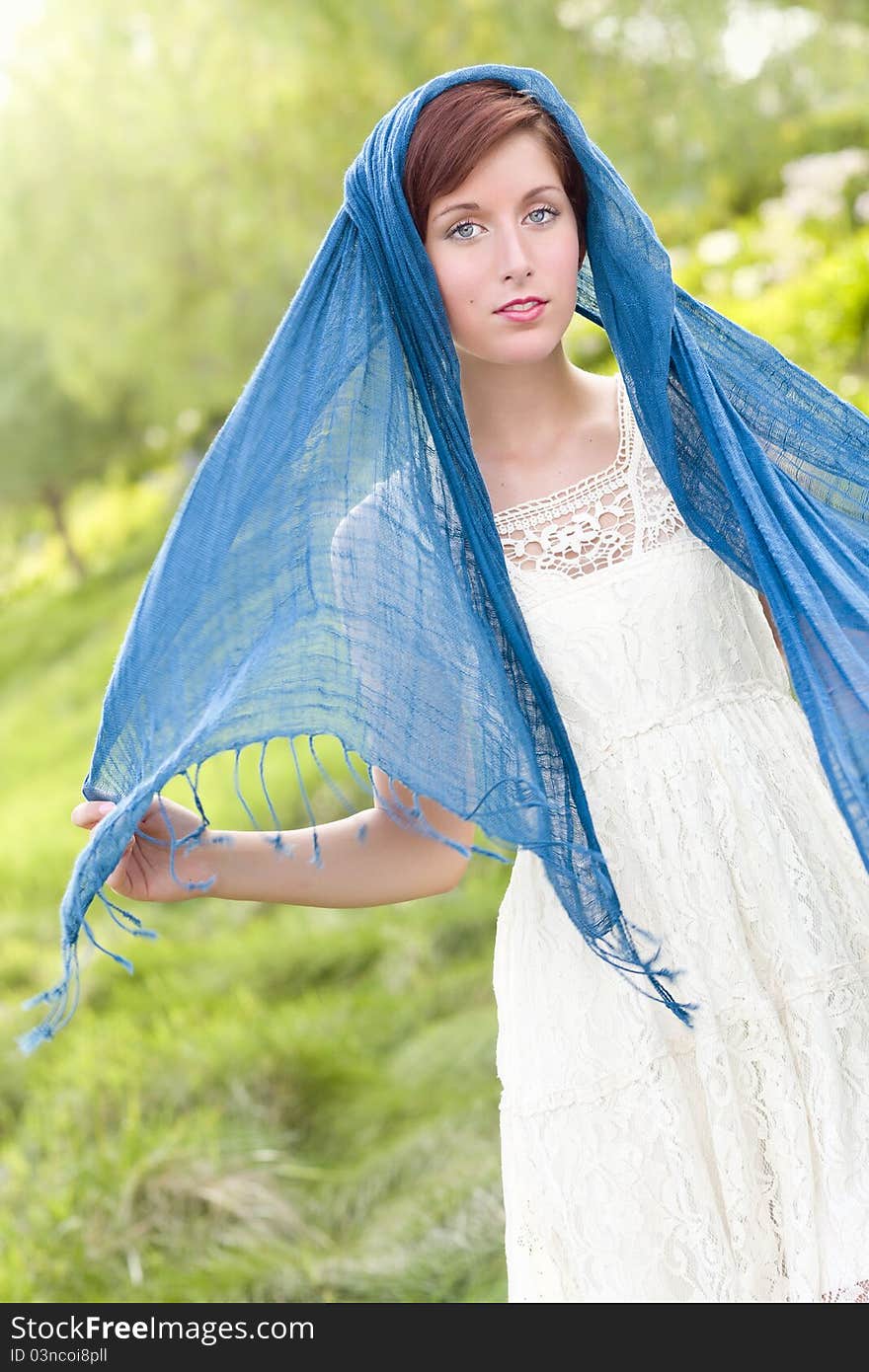 Outdoor Portrait of Pretty Blue Eyed Young Red Haired Adult Female with Blue Scarf. Outdoor Portrait of Pretty Blue Eyed Young Red Haired Adult Female with Blue Scarf.