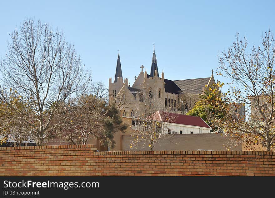 An old Christian church behind a wall in the city of Perth, Australia.