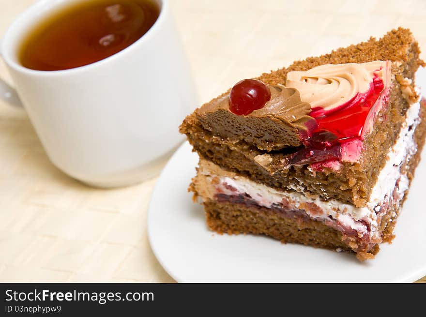 Cup of tea and plate with cake on table. Cup of tea and plate with cake on table