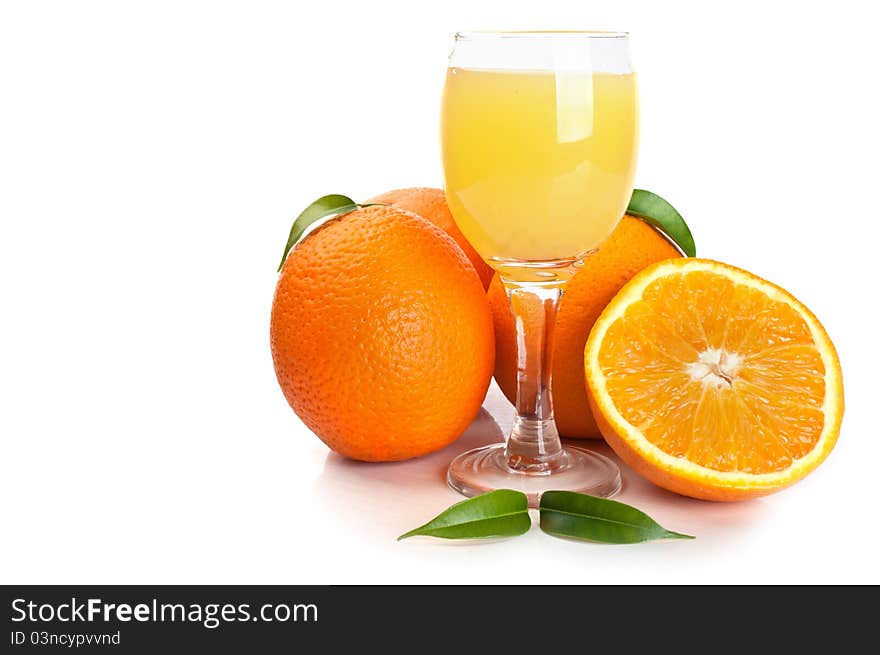 Orange juice in glass and fruits isolated on a white background