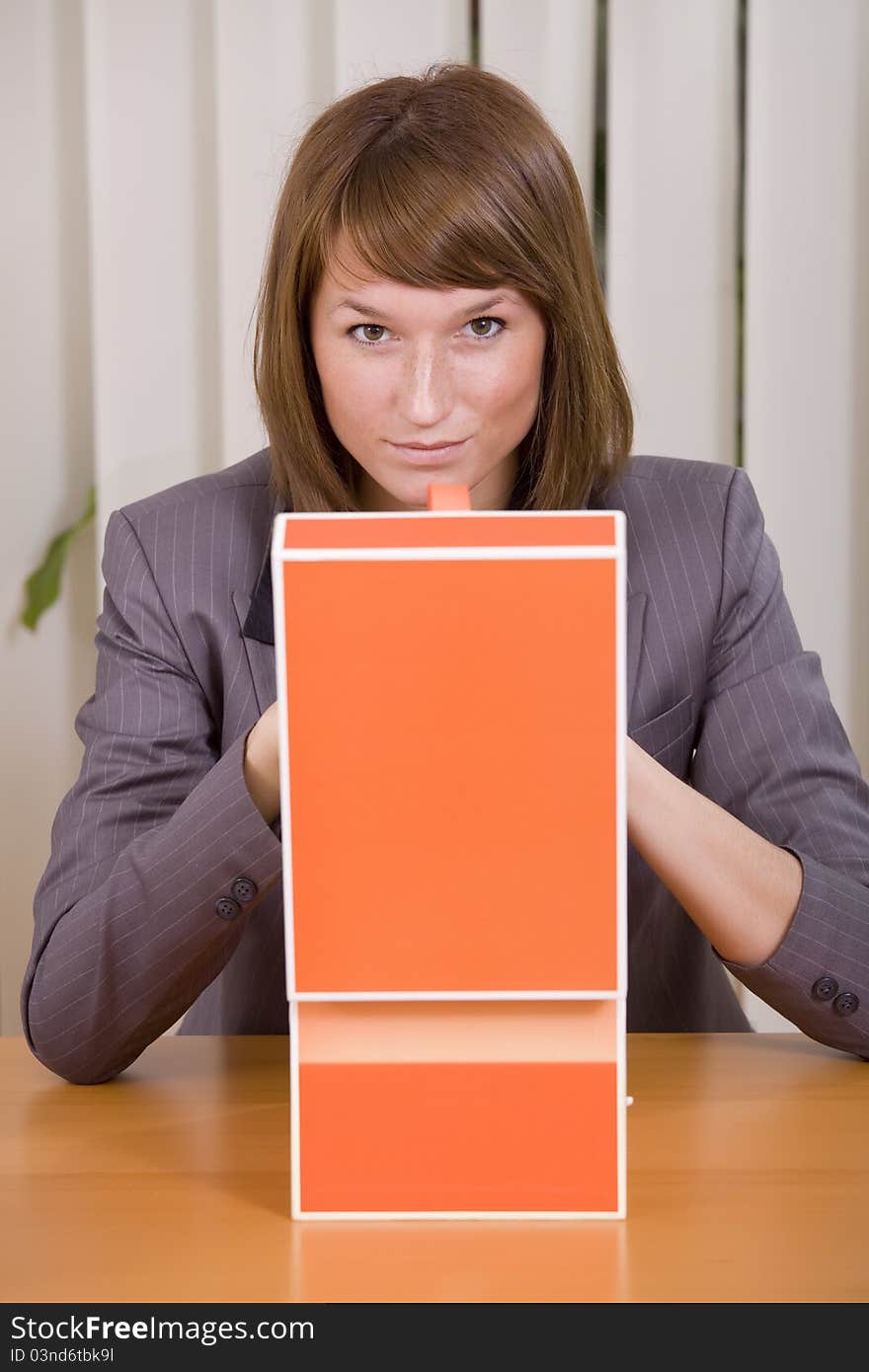 Thinking businesswoman with file card holder