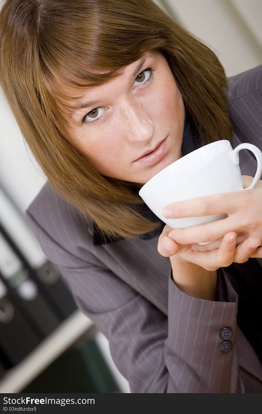 Woman Having Coffee Break At Office