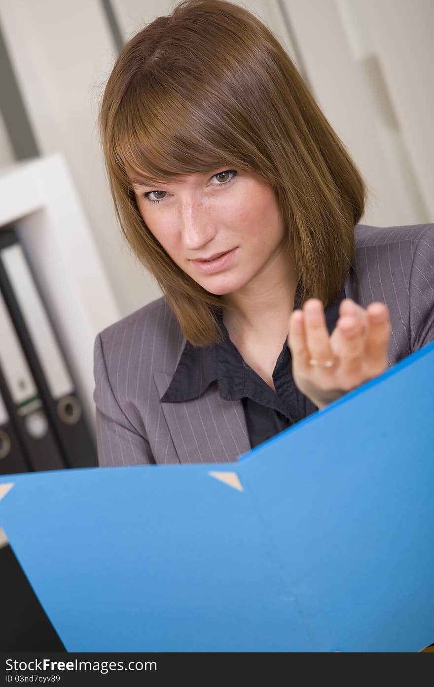 Young businesswoman holding file and discussing by office work. Young businesswoman holding file and discussing by office work