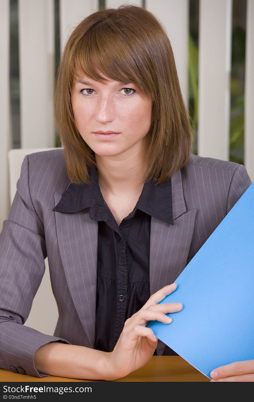 Portrait of businesswoman holding a file in office. Portrait of businesswoman holding a file in office