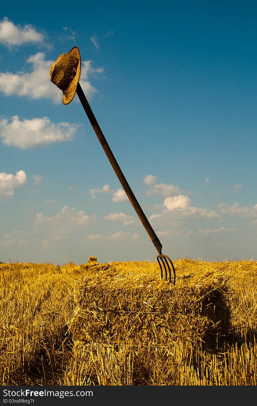 Wheat Straws Bale With Pitchfork And Hat