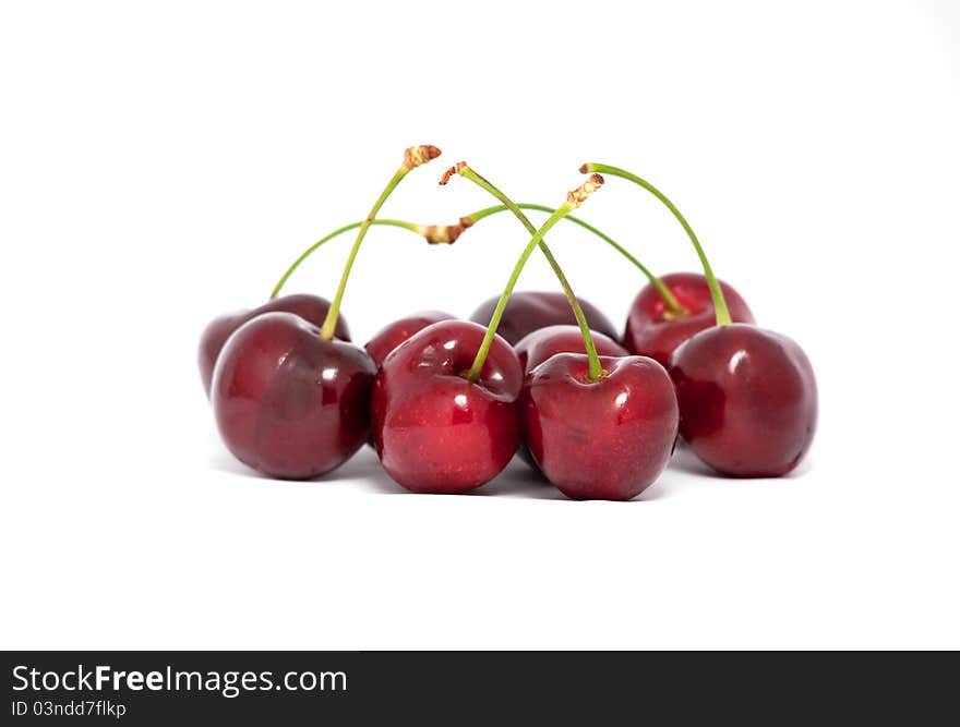 Red cherries with stems on white background