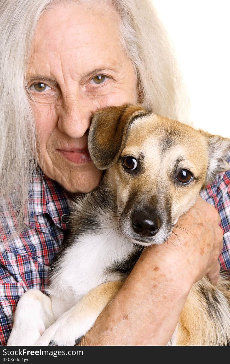 Beautiful senior woman holding her cute mixed breed puppy. Beautiful senior woman holding her cute mixed breed puppy