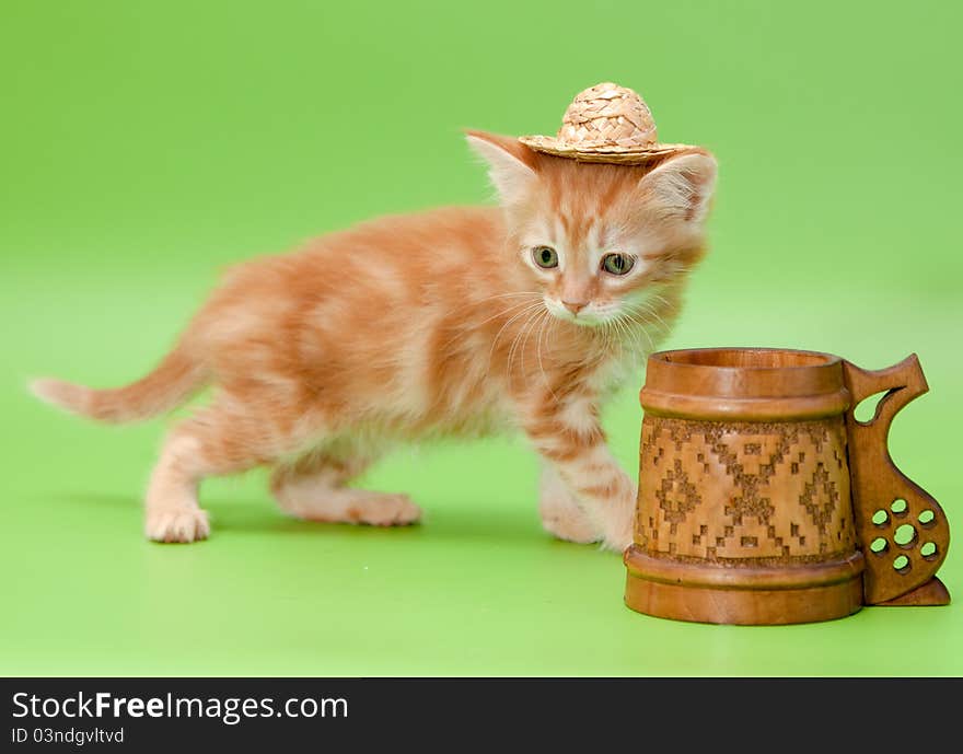 Ginger kitten in straw and carved mug